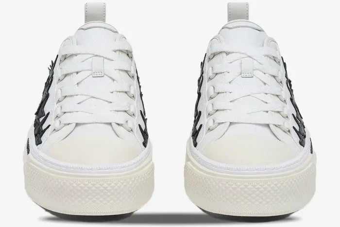 Front view of Amiri Stars Court low-top sneakers in white and black with star details. - SKU AMFOSR1179-111