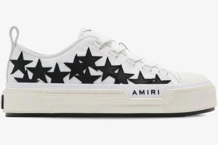 Side view of white Amiri Stars Court Low-Top Sneakers with black star patches and platform sole. - SKU AMFOSR1179-111