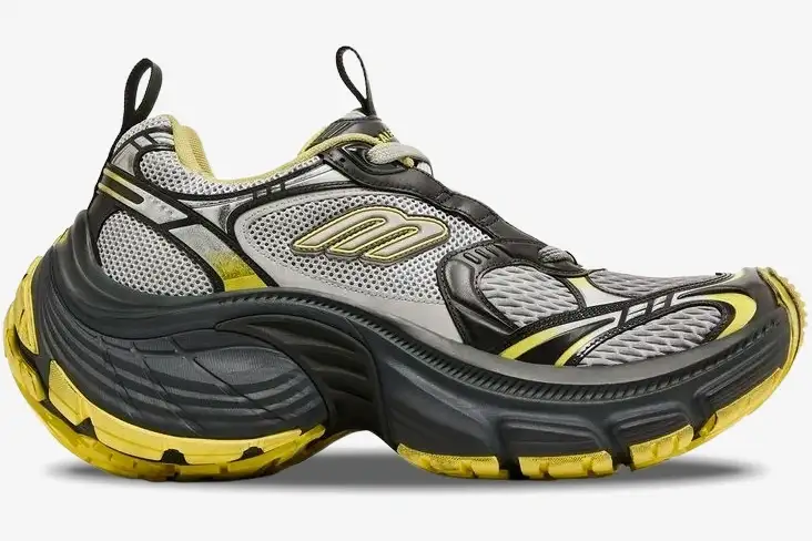 balenciaga-10xl-sneaker-grey-yellow-side-792779w2mv21097-469-396 Side profile of a Balenciaga 10XL sneaker in grey and yellow with a chunky distressed sole. - SKU 792779w2mv21097
