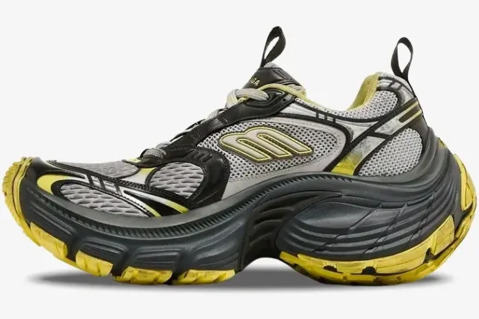Side profile of a Balenciaga 10XL Sneaker in grey and yellow distressed mesh with an oversized chunky sole. - SKU 792779w2mv21097
