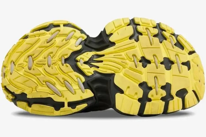 Bottom view of a Balenciaga 10XL sneaker featuring a chunky yellow and black textured outsole. - SKU 792779w2mv21097