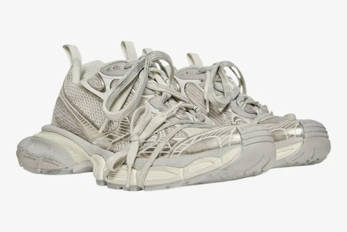A pair of Balenciaga 3XL reflective distressed mesh sneakers in beige, shown from a three-quarter side angle. - SKU 734734W3XL49191