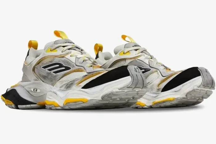 Balenciaga Cargo Sneaker in worn-out grey, yellow, and black, low-angle front-side view of a pair. - SKU 784341W2MV11170
