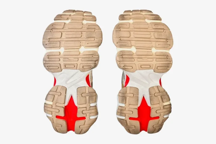 Bottom view of Balenciaga Cargo worn-out beige and red sneakers showing textured outsoles. - SKU 785754W2MV12160
