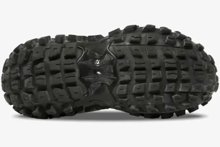 Bottom view of black Balenciaga Defender chunky sneaker showing tire-tread rubber outsole. - SKU 685613W2RA61000
