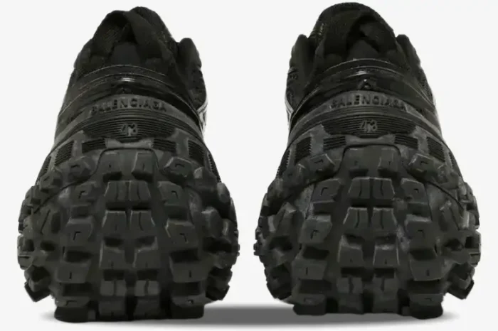 Rear view of Balenciaga Defender Chunky Sneakers in black, featuring oversized tire-tread soles and heel branding. - SKU 685613W2RA61000