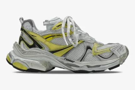 Side view of Balenciaga Runner 2 Distressed Mesh sneakers in silver and yellow with worn-out details. - SKU 779066W3RXP9710