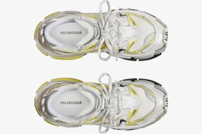 Top-down view of Balenciaga Runner 2 sneakers in distressed white mesh with silver and yellow accents. - SKU 779066W3RXP9710