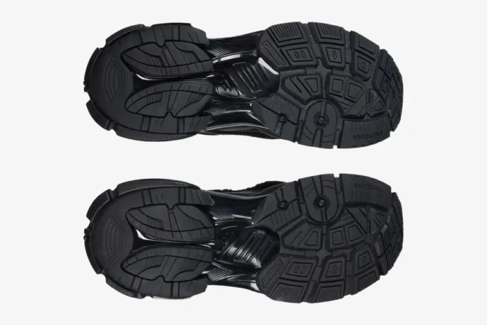 Bottom view of the textured black rubber outsoles on Balenciaga Runner all black distressed sneakers. - SKU 772774W3RBT1000