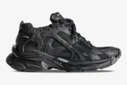 Side profile of a Balenciaga Runner All Black Distressed Sneaker with mesh panels and chunky sole. - SKU 772774W3RBT1000