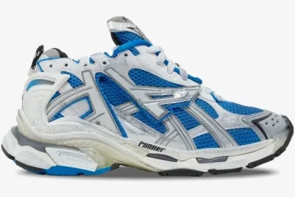 Side profile of a Balenciaga Runner sneaker featuring blue mesh with white and grey overlays. - SKU 677403W3RB34912