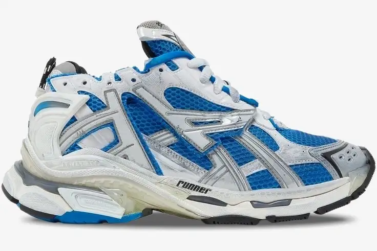 balenciaga-runner-blue-white-grey-side-view-677403w3rb34912-325-085 Side profile of a Balenciaga Runner sneaker featuring blue mesh with white and grey overlays. - SKU 677403W3RB34912
