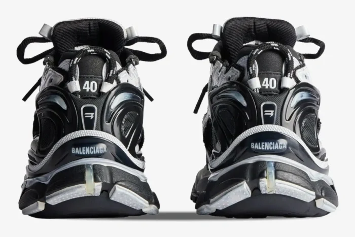 Rear view of Balenciaga Runner Sneaker Distressed Edition in black and white showing heel branding. - SKU 772774W3RMU9010