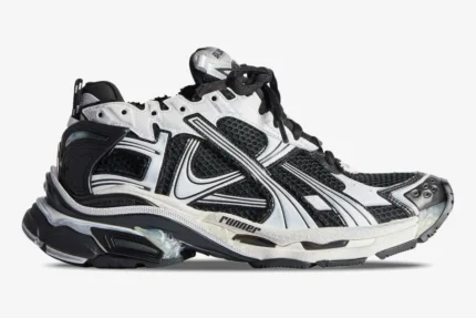 Side view of Balenciaga Runner Sneaker Distressed Edition in black and white mesh with visible glue details. - SKU 772774W3RMU9010