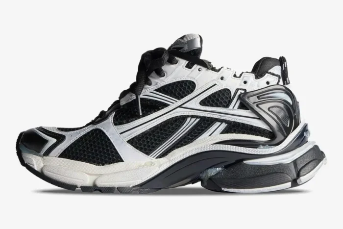 Side profile of Balenciaga Runner Sneaker Distressed Edition in black and white mesh with worn details. - SKU 772774W3RMU9010