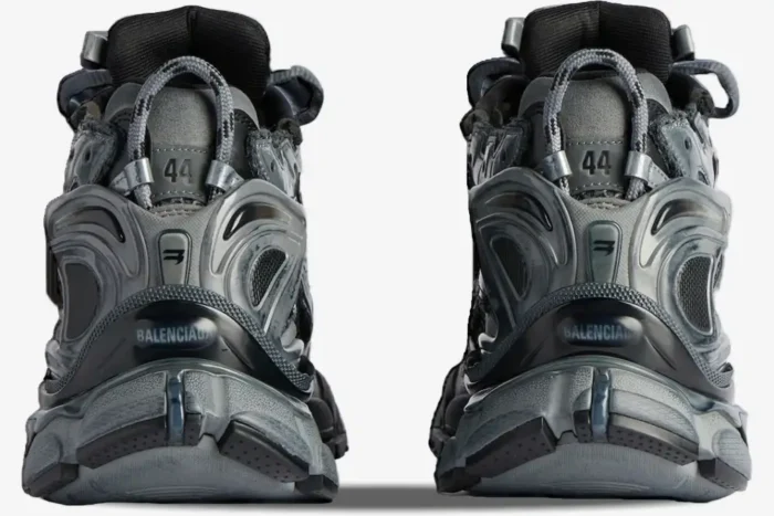 Rear view of Balenciaga Runner sneakers in distressed grey and silver showing heel branding and size 44. - SKU 677403W3RB11000