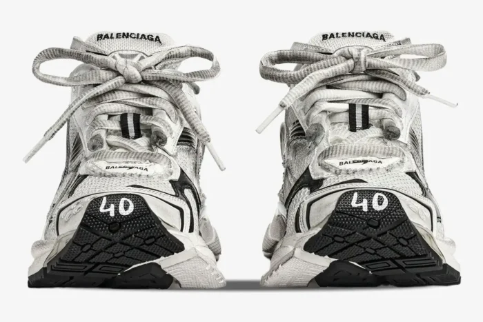 Front view of Balenciaga Runner Gradient Sneakers in white and black with a distressed finish and size 40 on the toe. - SKU 677403W3RB19010