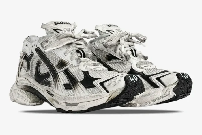 Three-quarter view of Balenciaga Runner Gradient sneakers in white and black with a distressed, worn-in look. - SKU 677403W3RB19010