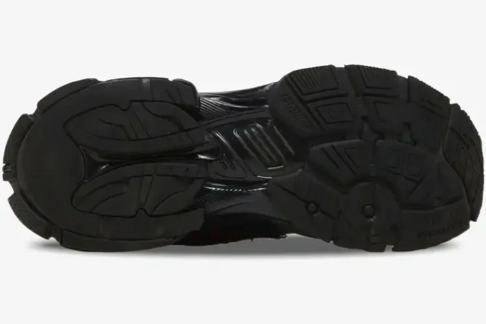 Bottom view of the black Balenciaga Runner Graffiti sneaker outsole with distressed details and tread pattern. - SKU 677403W3RBQ1060