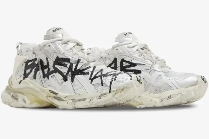 Side view of Balenciaga Runner Graffiti sneakers in white and black with a distressed finish. - SKU 677403W3RBQ9010