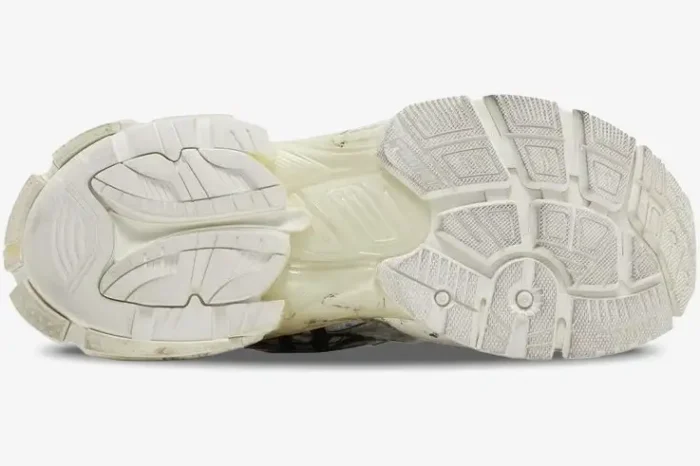 Bottom view of the white and black Balenciaga Runner Graffiti sneaker outsole showing its complex tread pattern. - SKU 677403W3RBQ9010