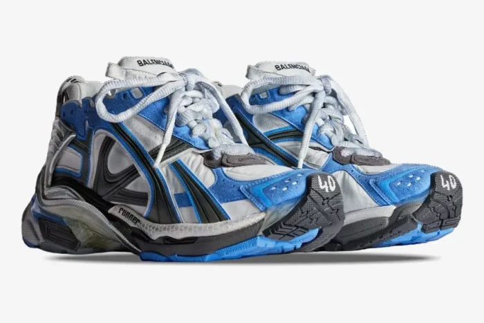 Balenciaga Runner sneakers in blue, white, and grey distressed mesh, shown from a three-quarter side angle. - SKU 677403W3RB14912