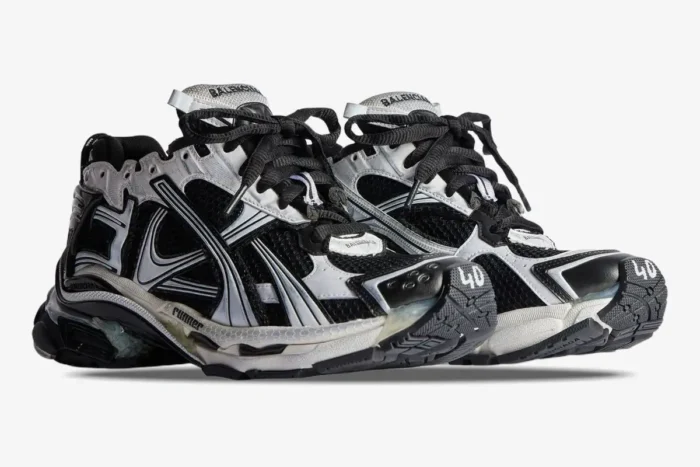 Balenciaga Runner Sneaker Distressed Edition in black and white, side three-quarter view. - SKU 772774W3RMU9010