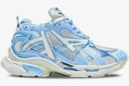 Side profile of a Balenciaga Runner Sneaker in light blue and white with a chunky layered sole. - SKU 677402W3RB29744