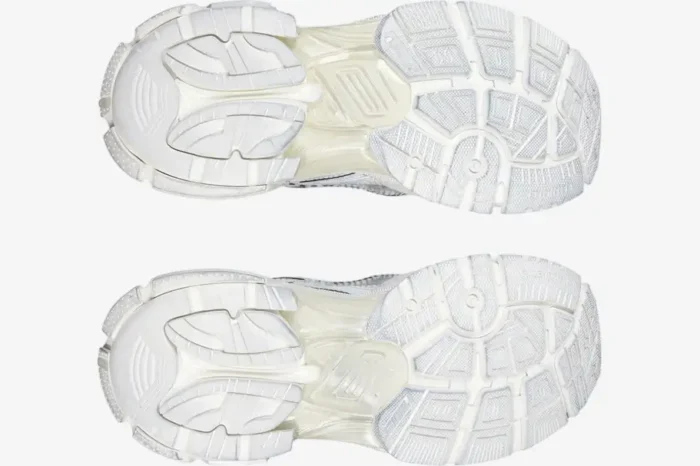 Bottom view of white Balenciaga Runner Sneakers showing the intricate, chunky textured rubber soles. - SKU 772774W3RMU9000