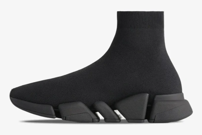 Side profile of a black Balenciaga Speed 2.0 Recycled Knit Sneaker with a segmented sole. - SKU 617239W2DB11013