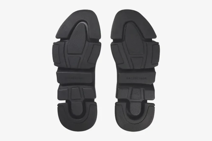 Bottom view of black Balenciaga Speed 2.0 Recycled Knit Sneaker outsoles showing tread pattern. - SKU 617239W2DB11013