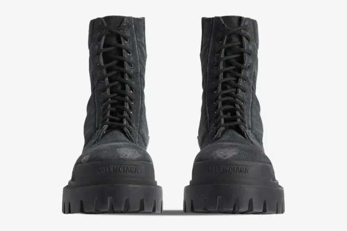 Front view of Balenciaga Strike Combat Boots in distressed black canvas with chunky lug soles. - SKU 694042W2H111000