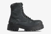 Side profile of Balenciaga Strike combat boots in distressed black canvas with a chunky lugged sole. - SKU 694042W2H111000
