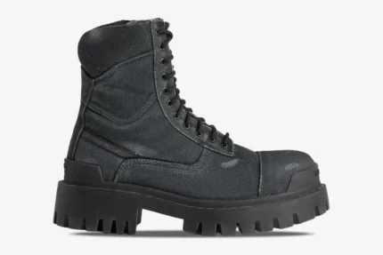 Side profile of Balenciaga Strike combat boots in distressed black canvas with a chunky lugged sole. - SKU 694042W2H111000