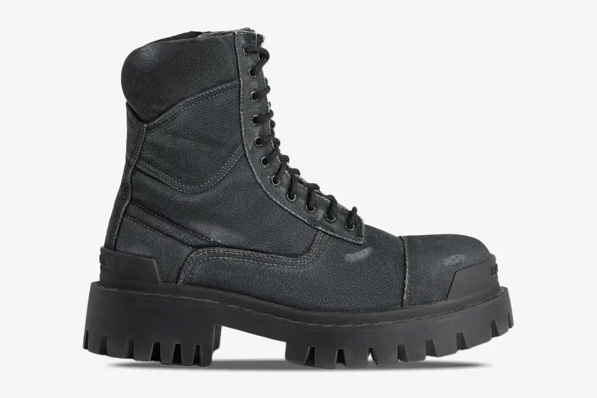 balenciaga-strike-distressed-canvas-boot-side-694042w2h111000-535-276 Side profile of Balenciaga Strike combat boots in distressed black canvas with a chunky lugged sole. - SKU 694042W2H111000