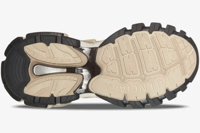 Bottom sole view of Balenciaga Track 2.0 sneakers in beige, black, and silver with rugged tread. - SKU 568614W2GN39170
