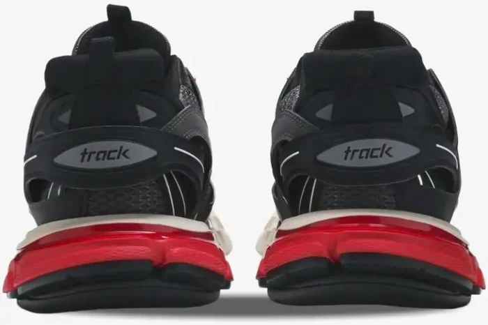 Rear view of Balenciaga Track sneakers in black, grey, and red, showing the heel logo and layered sole. - SKU 542023W1GB61002