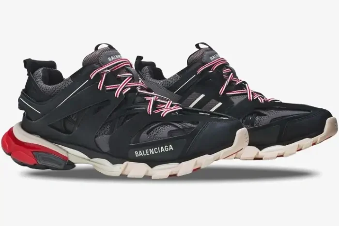 Side profile of Balenciaga Track sneakers in black, grey, and red with striped laces. - SKU 542023W1GB61002