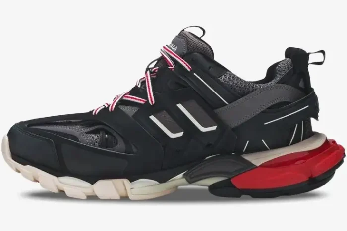 Side profile of Balenciaga Track sneakers in black, grey, and red with layered mesh and chunky soles. - SKU 542023W1GB61002