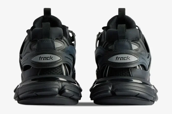 Rear view of Balenciaga Track sneakers in black mesh and nylon with 'track' logo on the heel. - SKU 542023W1GB11000