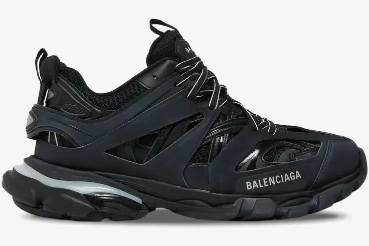 balenciaga-track-led-black-side-view-555036w2gb11000-703-615 Side profile of a black Balenciaga Track Led sneaker with a chunky multi-layered design and light-up sole. - SKU 555036W2GB11000