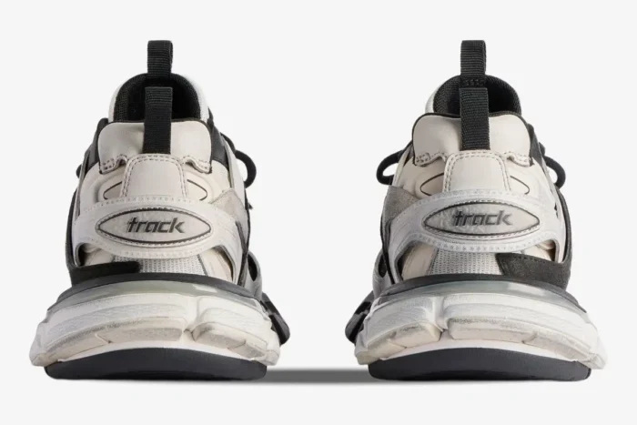 Rear view of Balenciaga Track Low Sneakers in grey, black, and white showing the heel branding. - SKU 542023W3SU59791