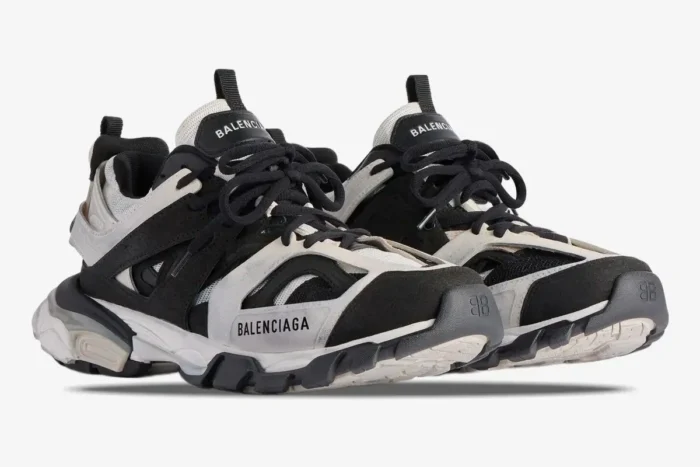 Balenciaga Track Low Sneakers in grey, black, and white, shown from a three-quarter front angle. - SKU 542023W3SU59791