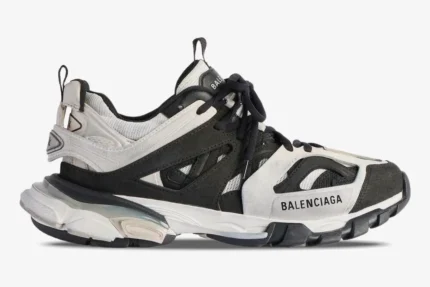 Side profile of Balenciaga Track Low sneakers in grey, black, and white with layered panels and chunky soles. - SKU 542023W3SU59791