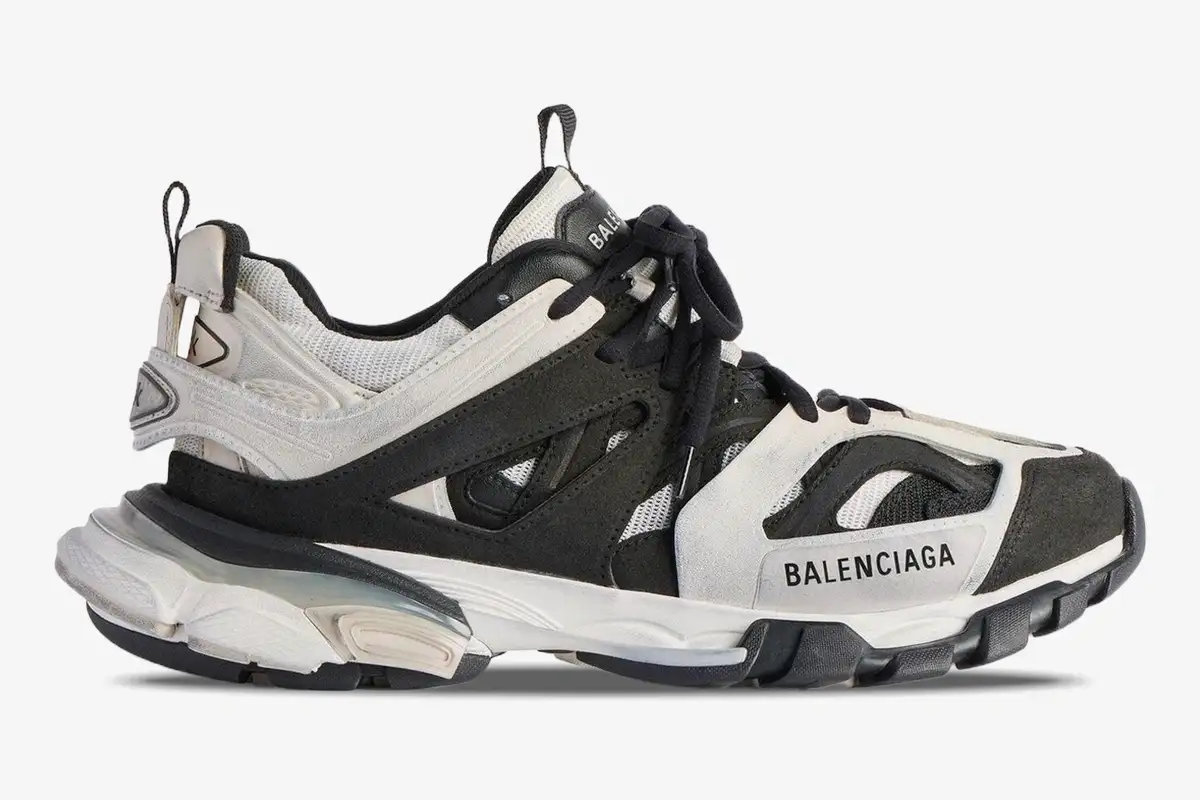 balenciaga-track-low-grey-black-white-side-view-542023w3su59791-870-005 Side profile of Balenciaga Track Low sneakers in grey, black, and white with layered panels and chunky soles. - SKU 542023W3SU59791