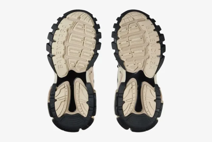 Bottom view of Balenciaga Track Sneakers in beige and black, showing the detailed chunky rubber outsoles. - SKU 542023W3AC48071