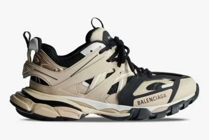 Side profile of a Balenciaga Track sneaker in beige, black, and white with a layered design. - SKU 542023W3AC48071