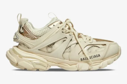 Side profile of a Balenciaga Track Sneaker in beige cream with layered mesh and nylon panels. - SKU 542436W2LA29110