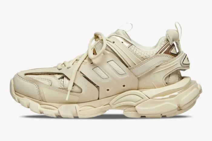 Side profile of a Balenciaga Track Sneaker in beige cream with a complex layered design and chunky sole. - SKU 542436W2LA29110