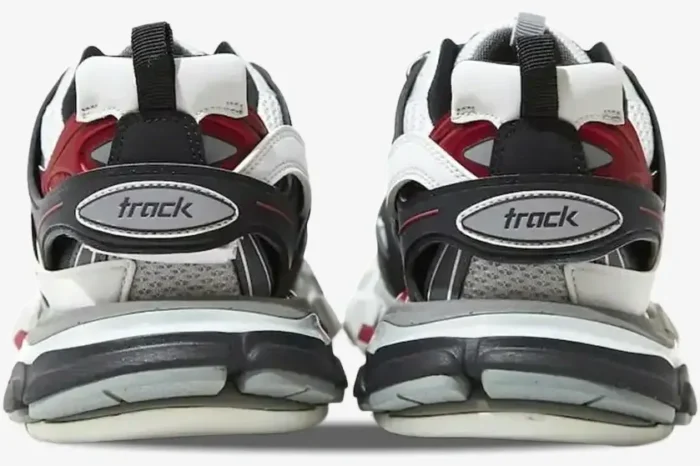 Rear view of Balenciaga Track sneakers in black, red, and white showing the 'track' logo on the heels. - SKU 542023W1GB81285